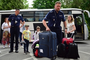 Policjanci żegnają rodziny uchodźców z Ukrainy.